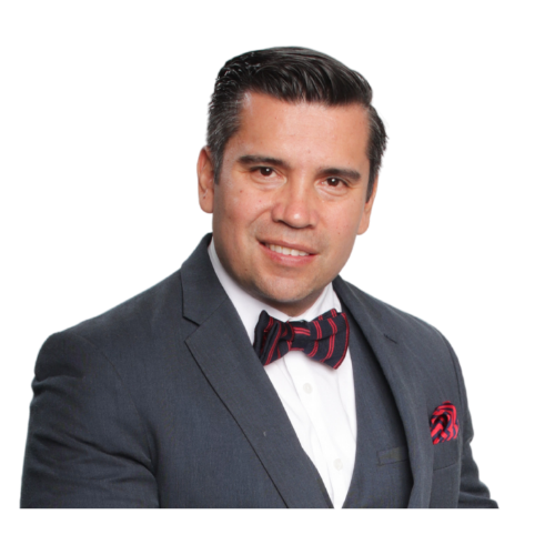 Felipe Rodriguez with dark hair styled neatly, wearing a dark suit, white shirt, and a red and black striped bow tie, poses for a formal portrait against a plain white background, embodying the polished professionalism Coaching Client of Keep It Simple Coach Dr. Yam
